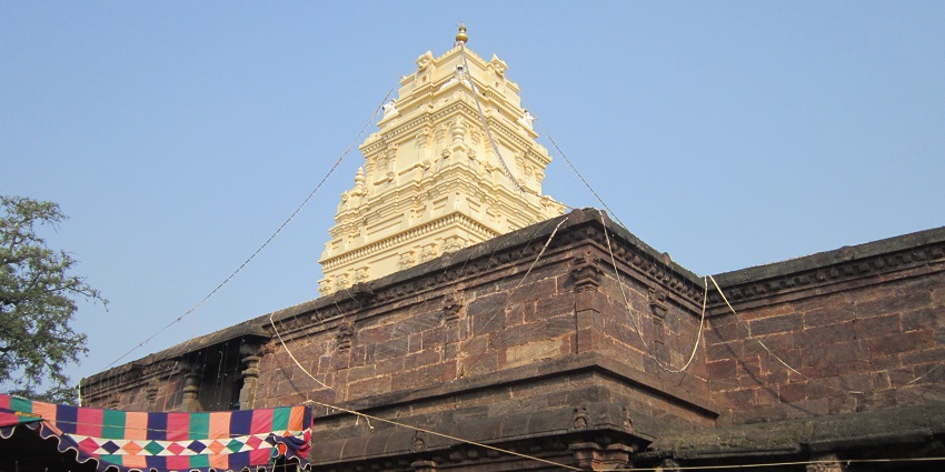 A picture of a temple built in the traditional Hindu architecture and intricate designs