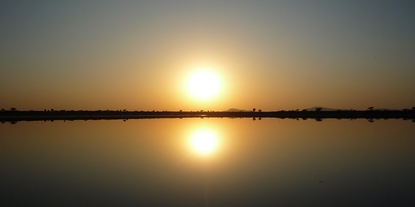 Sunset over Sambhar Lake, with vibrant colours reflecting on the calm water