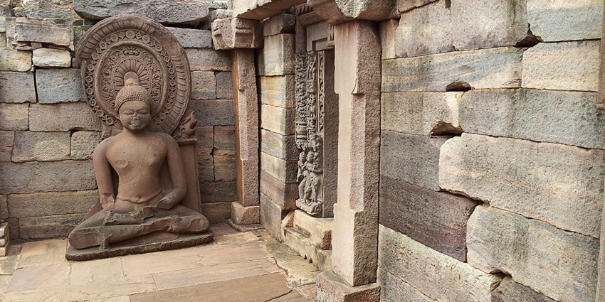 Interior view of Sanchi Stupa, a popular destination near Salkanpur Temple, featuring a detailed, ancient stone carving of Buddha.
