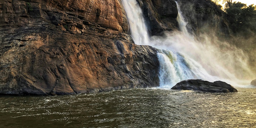 A picture of one of the most relaxing places to visit in Araku with a waterfall surrounded by greenery