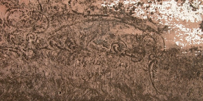 A picture of an ancient inscription made on the walls of the ruins of a historical building