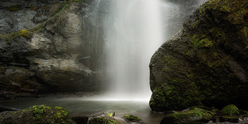 Picturesque view of waterfalls cascading through rocks making pond for swimming