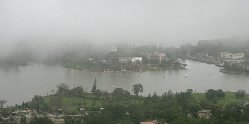 The view of dense forest and lake in the misty climate surrounded by the dense greenery of Saputara