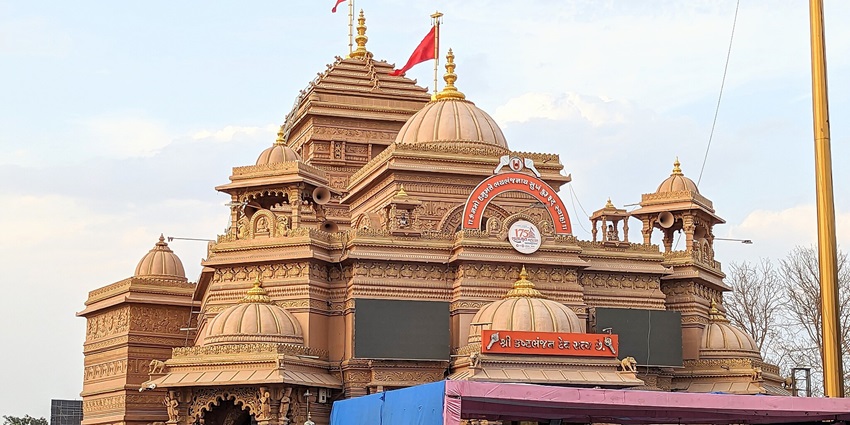 This temple features an elaborate design and a large crowd in the temple complex.