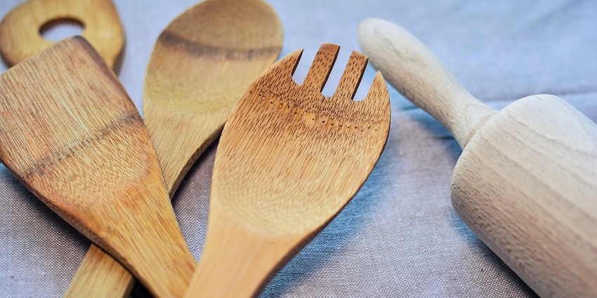 Various stainless steel kitchen equipment and tools are neatly arranged, representing household shopping in Ahmedabad.