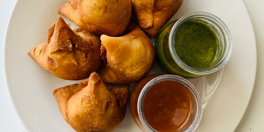 Samosa is a local snack served with a mint chutney and eaten with tea