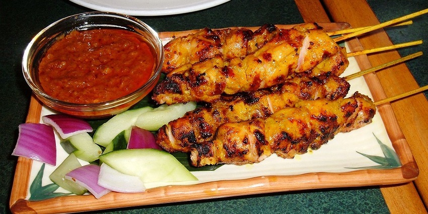 Chicken satay skewers served with peanut sauce - one of the best foods in Singapore.