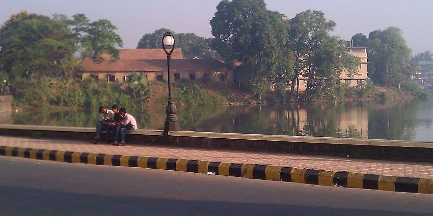 A group of young boys sitting near the pond of Sawantwadi which is a beautiful hill station near Goa