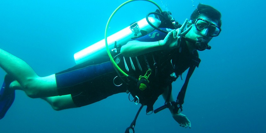 A scuba diver exploring the vibrant underwater world of the Goa's clear sea.