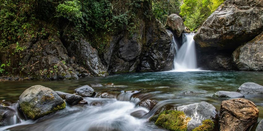 Senua Waterfall is a beautiful and tall waterfall situated in a rugged forest terrain.