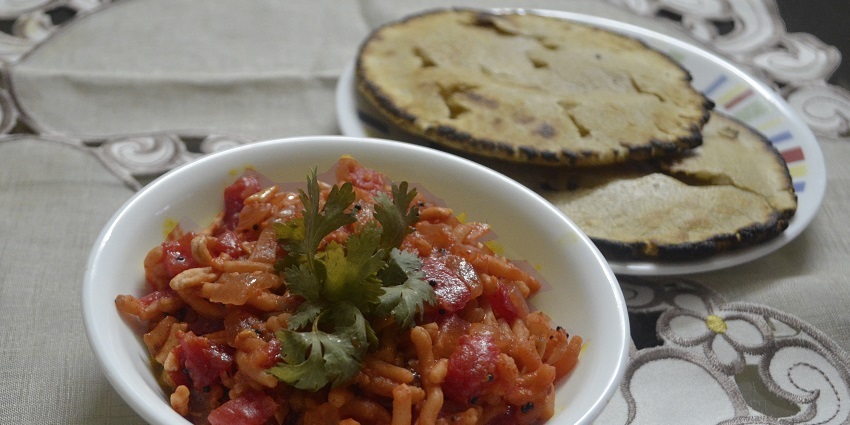 Sev Tameta, spicy sev with a tangy tomato gravy is a famous street food in Rajkot.