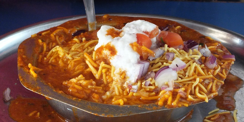 Sev Usal served in a bowl garnished, one of the best street food in Ahmedabad.