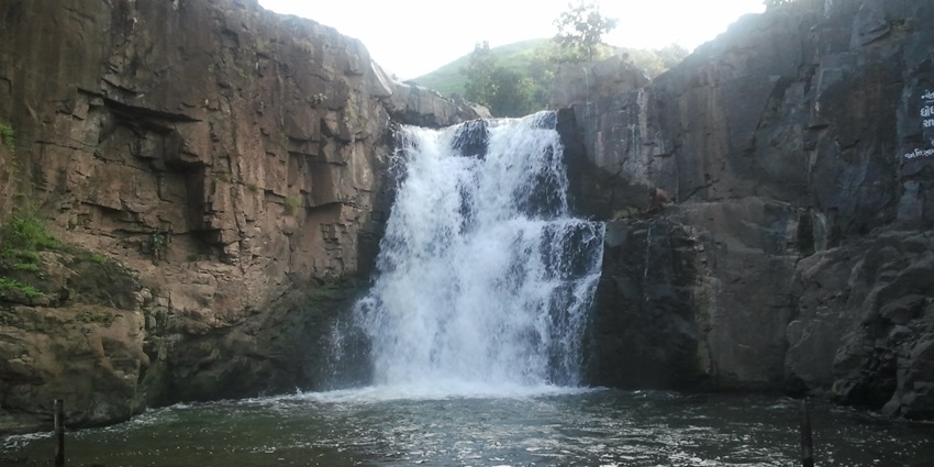 A beautiful waterfall flowing through rocky terrain.