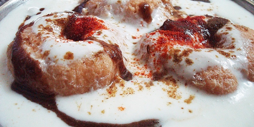 Image of a plate of dahi bhalle soaked in yoghourt - street food in Khan Market