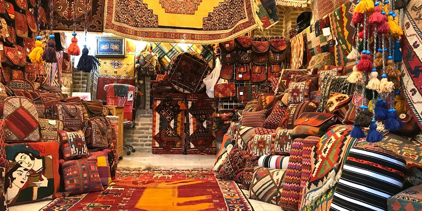 A glimpse of traditional mats, pillows, and handbags being sold at Shahpur Jat market.