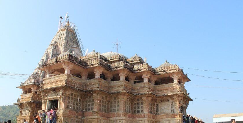 Picturesque view of the Shamlaji temple with tourists walking in and out of the building