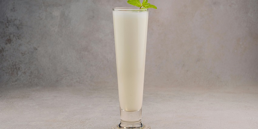 Shankar Lassi & Sweets showcasing a refreshing glass of lassi topped with mint leaves.