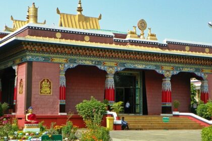 A peaceful view of Shechen monastery in Bodhgaya, Nepal, India, surrounded by trees.