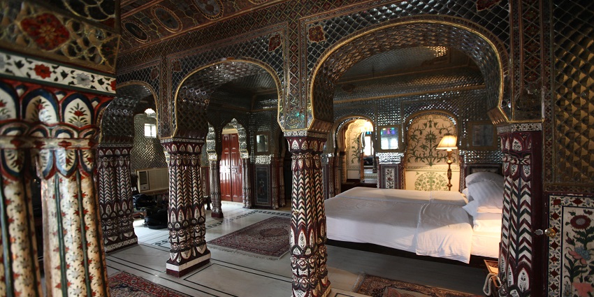 A regal bedroom of Sheesh Mahal, among the top tourist attractions near Mehrangarh Fort.