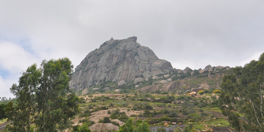 A scenic picture of a lush green foothill near Bangalore, surrounded by lush greenery