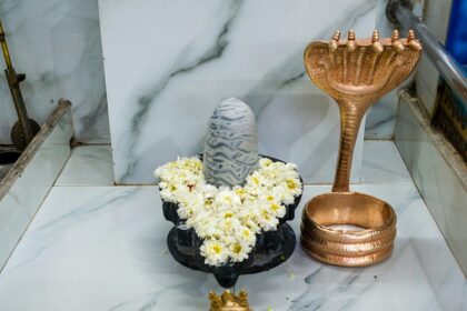 Shivling temple with gold accessories, featuring a sleek, modern design - Surutapalli temple.