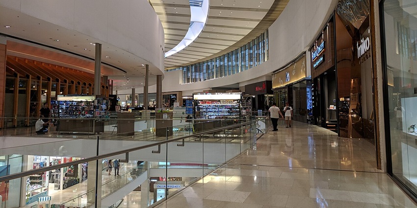 Image of a shopping mall inside view where people are strolling around and shopping