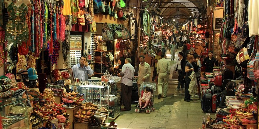 View of a vibrant narrow street in the local markets of the city with shops displaying a variety of items