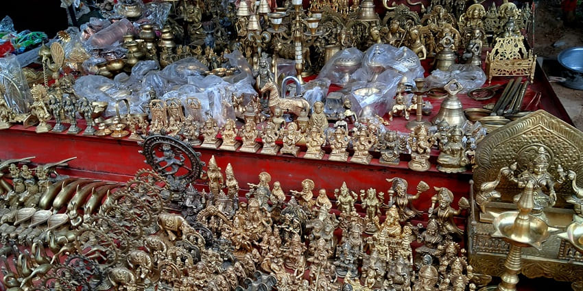 A picture of a local handicraft stall in Nellore selling small brass statues of deities