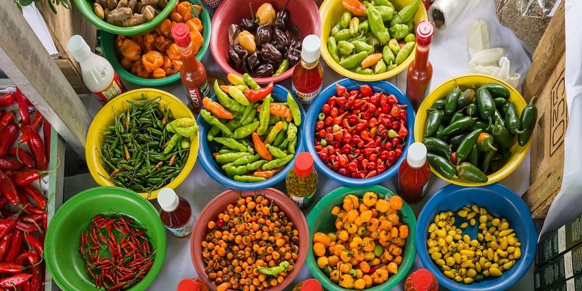 Colorful Capsicum baccatum peppers displayed at a flea market in Rohtak.
