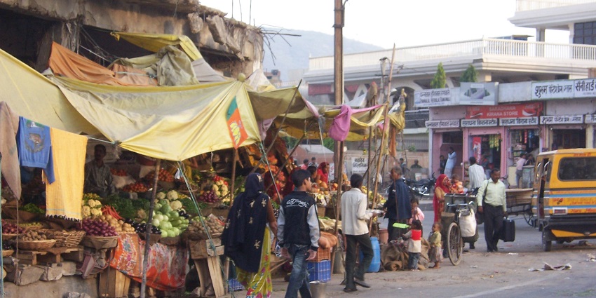 Street scene in Jaipur's Johari Bazaar, bustling with vibrant colours and lively shops.