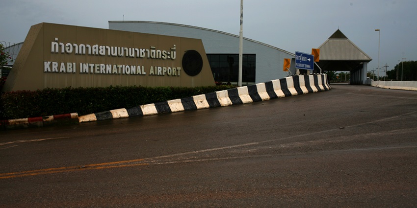 Main entrance road to Krabi International Airport, Thailand, with its nameboard.