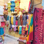 Shopping in Jaisalmer markets bustle with handicrafts and textiles showcasing cultural heritage.