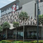 Shoppers exploring a modern shopping mall in Surat with bright interiors.