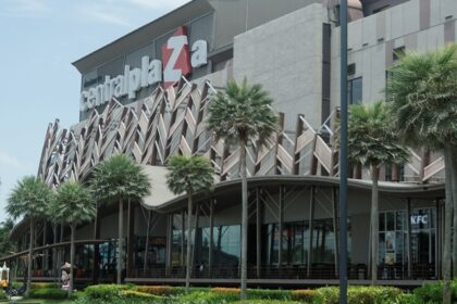 Shoppers exploring a modern shopping mall in Surat with bright interiors.