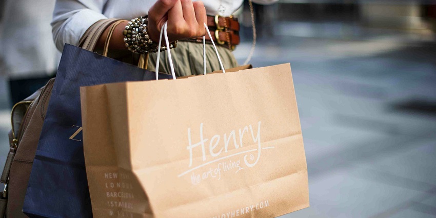 Women holding A brown paper bag surface and showcasing its simple, rustic charm.