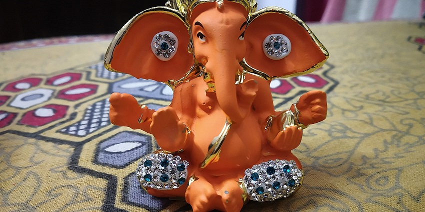 Statue of Lord Ganesha, the elephant-headed deity, adorned with colourful clothing.