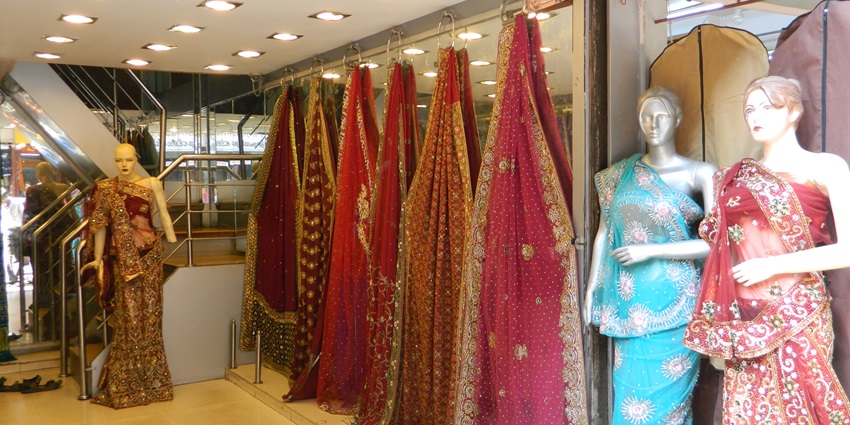 A picture of a garment store in Nathdwara with sarees put up on mannequins for display