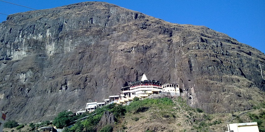 Image of Shree Saptashrungi Nivasini Devi Mandir on top of the hill under clear blue sky