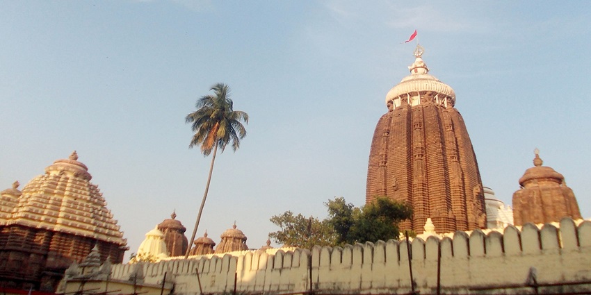 The Shri Jagannath Puri Temple, a striking red structure adorned with multiple spires