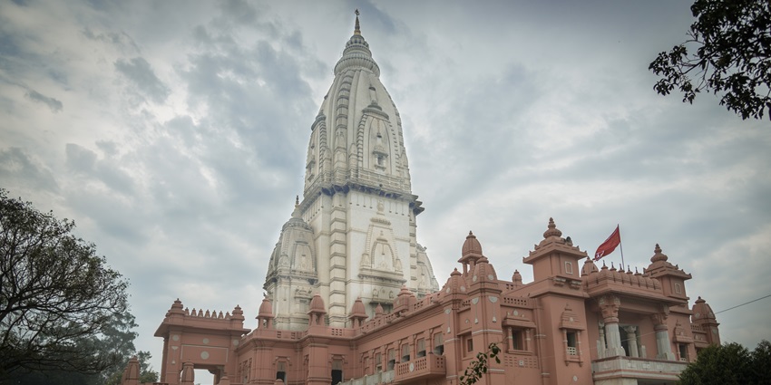 This temple, among Mahadev Temples in Gujarat, features a prominent tall tower, showcasing architectural design.