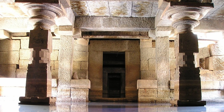 Image of serene temple reflected in calm water, surrounded by lush greenery