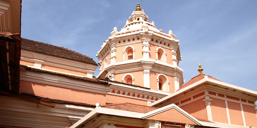 Intricate carvings adorn the entrance of a temple in Goa, showcasing traditional Indian architectural design