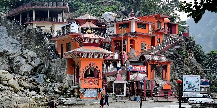 A vibrant Hindu temple complex situated in the lush greenery and rocky terrain among Shiva temples in Nepal.