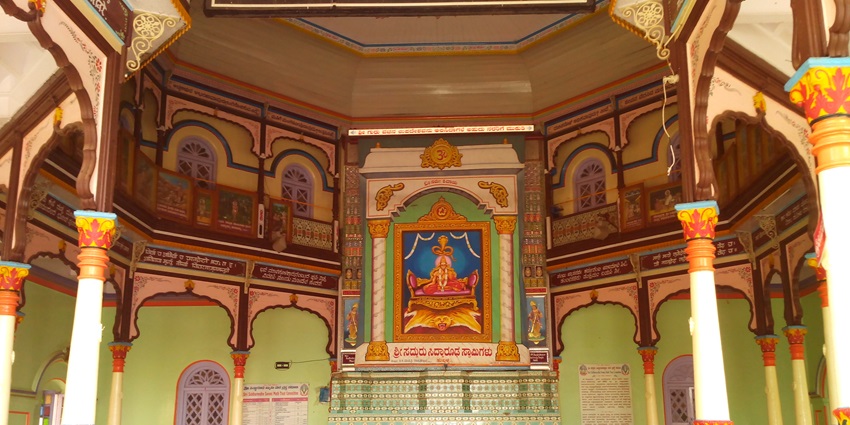 An inside view of the Siddharoodha Math featuring colourful walls and intricate designs.
