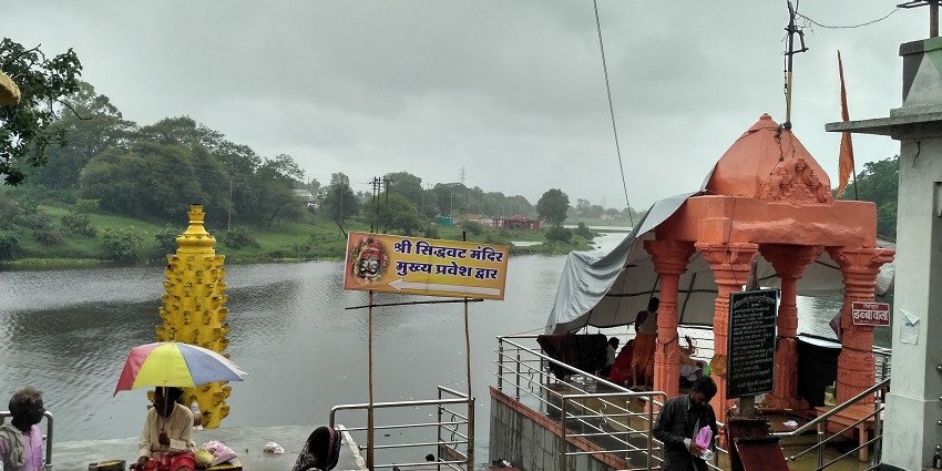 A view of Siddhavat Temple with a sacred tree and a small shrine in Ujjain, India.