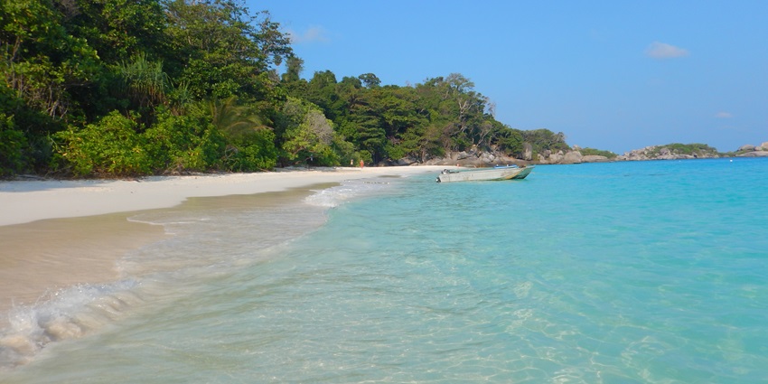 A picture of a beautiful beach at the Similan Islands with turquoise waters and lush greenery