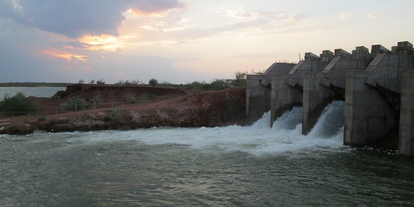 Dholi Dhaja Dam Gate, a sturdy structure controlling water flow, surrounded by nature