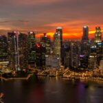 Singapore skyline at sunset, showcasing the city's skyscrapers and urban landscape.