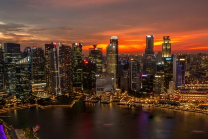 Singapore skyline at sunset, showcasing the city's skyscrapers and urban landscape.