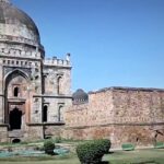 A picture of a fort in Delhi that was built in the 14th century with a garden in front of it